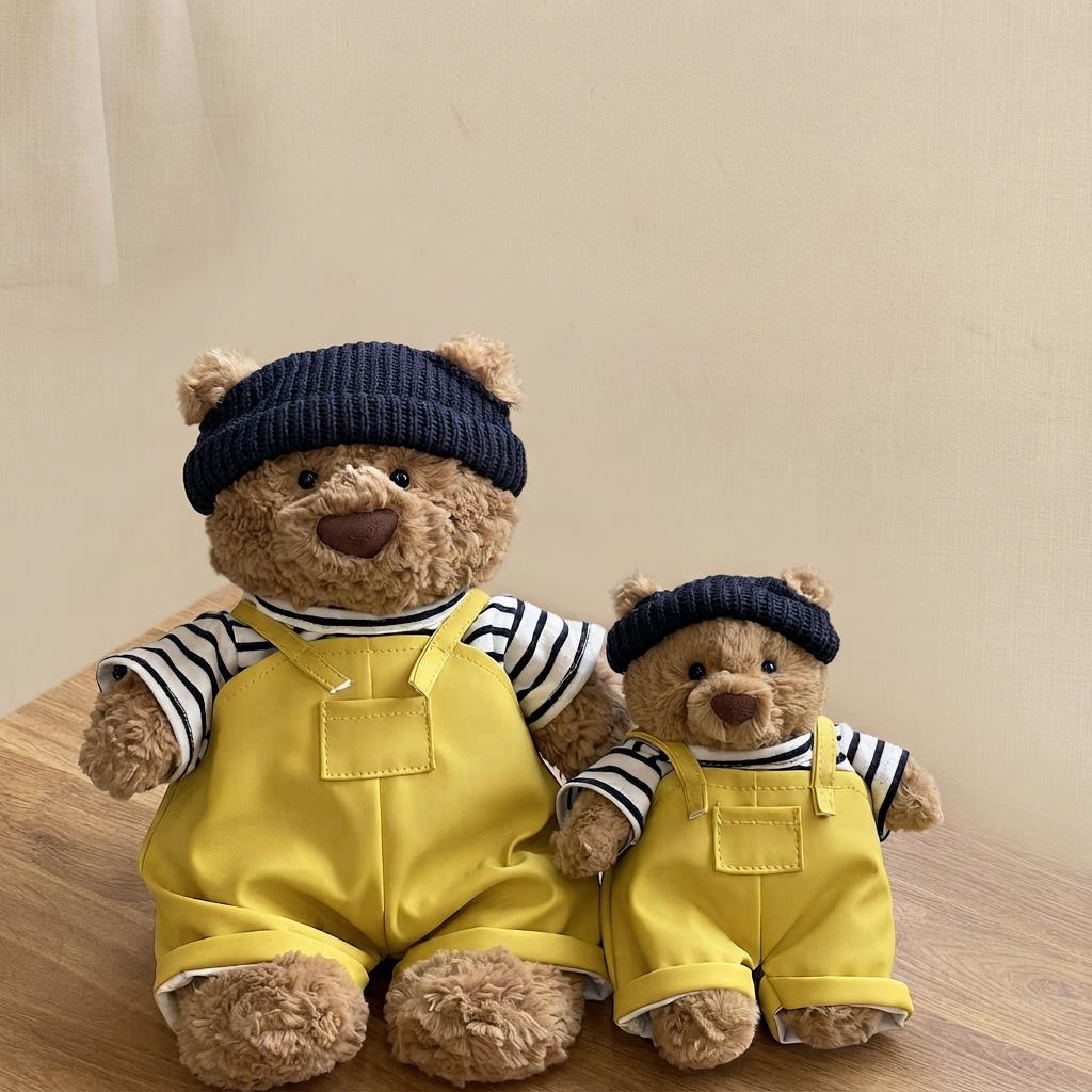 Two Bartholomew Bear plush toys wearing matching yellow sailor outfit sets